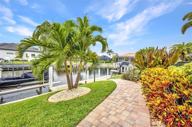 250 Freeport Ct, Punta Gorda, FL 33950 - view of grassy yard featuring boat lift, a dock, a water view, and a residential view