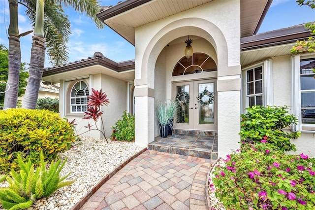 250 Freeport Ct, Punta Gorda, FL 33950 - doorway to property with stucco siding and french doors