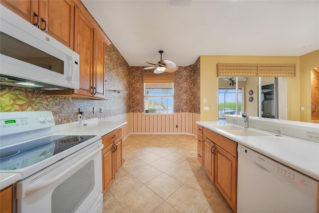 1527 Aqui Esta Dr Unit 3, Punta Gorda, FL 33950 - kitchen featuring white appliances, light countertops, brown cabinetry, a ceiling fan, and wallpapered walls