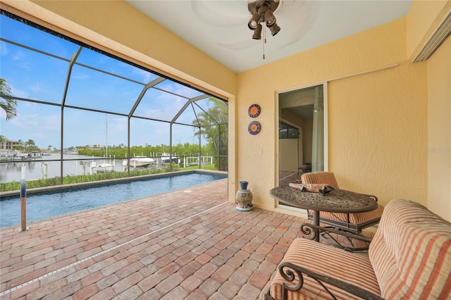 1527 Aqui Esta Dr Unit 3, Punta Gorda, FL 33950 - view of patio featuring a water view, a ceiling fan, an outdoor pool, and glass enclosure