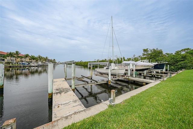 1527 Aqui Esta Dr Unit 3, Punta Gorda, FL 33950 - dock area featuring boat lift, a water view, and a lawn