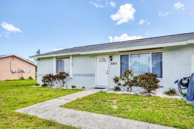 5983 Hobhill Ave, North Port, FL 34287 - view of front of home with stucco siding and a front yard