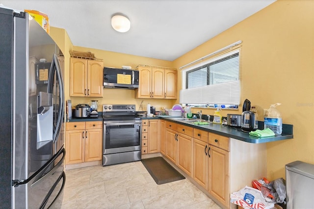 5983 Hobhill Ave, North Port, FL 34287 - kitchen featuring appliances with stainless steel finishes, light brown cabinets, a sink, and dark countertops