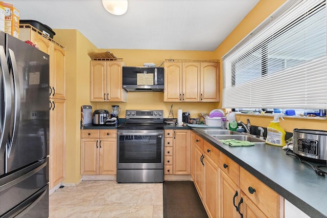 5983 Hobhill Ave, North Port, FL 34287 - kitchen featuring stainless steel appliances, a sink, light brown cabinetry, and dark countertops