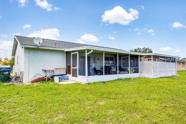 5983 Hobhill Ave, North Port, FL 34287 - back of property with a sunroom, a yard, and stucco siding