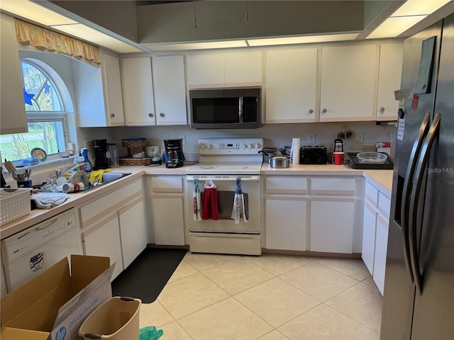 26312 Deep Creek Blvd, Punta Gorda, FL 33983 - kitchen with white appliances, light countertops, white cabinetry, and light tile patterned flooring