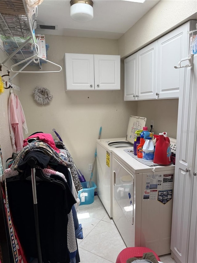 26312 Deep Creek Blvd, Punta Gorda, FL 33983 - washroom featuring washer and clothes dryer, cabinet space, and light tile patterned floors