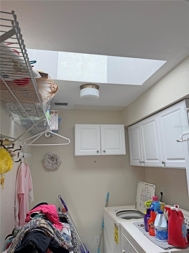 26312 Deep Creek Blvd, Punta Gorda, FL 33983 - laundry room with washing machine and dryer, cabinet space, and a skylight