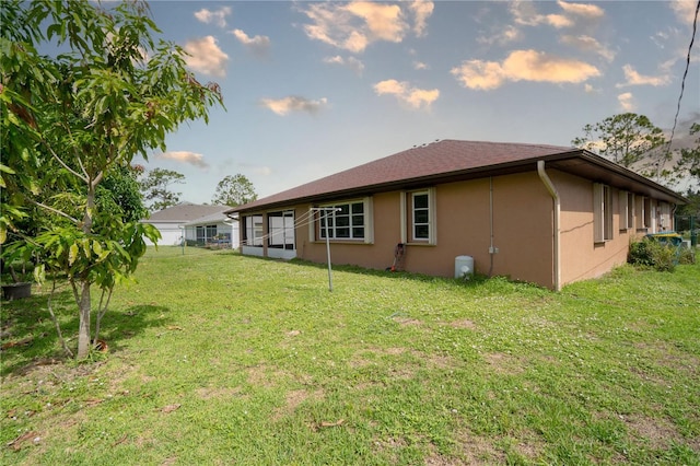23101 Hillsdale Ave, Port Charlotte, FL 33954 - back of property with stucco siding and a lawn