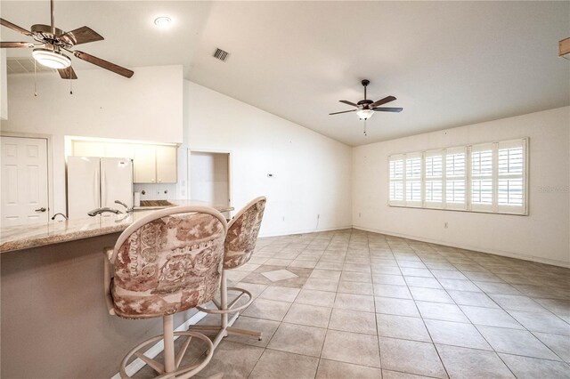 23101 Hillsdale Ave, Port Charlotte, FL 33954 - living area featuring ceiling fan, light tile patterned flooring, baseboards, and high vaulted ceiling