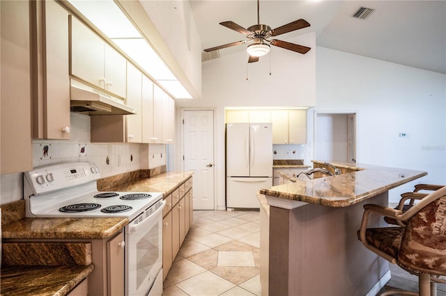 23101 Hillsdale Ave, Port Charlotte, FL 33954 - kitchen with white appliances, under cabinet range hood, a breakfast bar, high vaulted ceiling, and ceiling fan