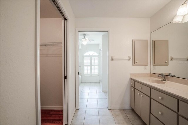 23101 Hillsdale Ave, Port Charlotte, FL 33954 - bathroom with vanity, tile patterned floors, a spacious closet, baseboards, and a ceiling fan