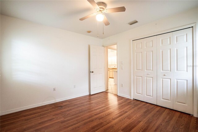23101 Hillsdale Ave, Port Charlotte, FL 33954 - unfurnished bedroom with wood finished floors, baseboards, a closet, and a ceiling fan