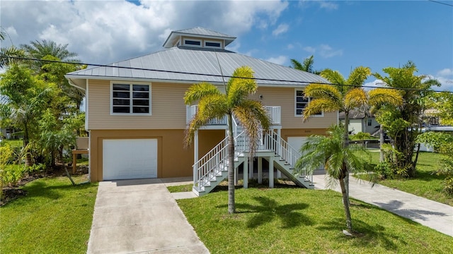 24261 Captain Kidd Blvd, Punta Gorda, FL 33955 - coastal inspired home with an attached garage, stairs, driveway, and a front yard