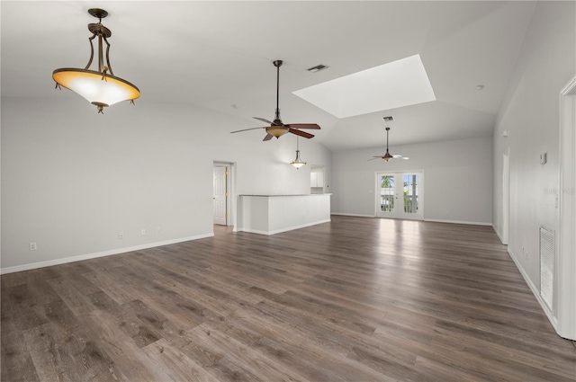 24261 Captain Kidd Blvd, Punta Gorda, FL 33955 - unfurnished living room with ceiling fan, vaulted ceiling, dark wood-style floors, and a skylight