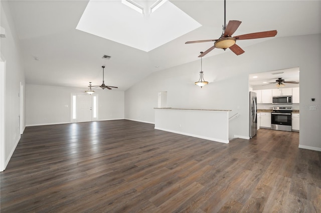 24261 Captain Kidd Blvd, Punta Gorda, FL 33955 - unfurnished living room with vaulted ceiling, ceiling fan, dark wood finished floors, and a skylight