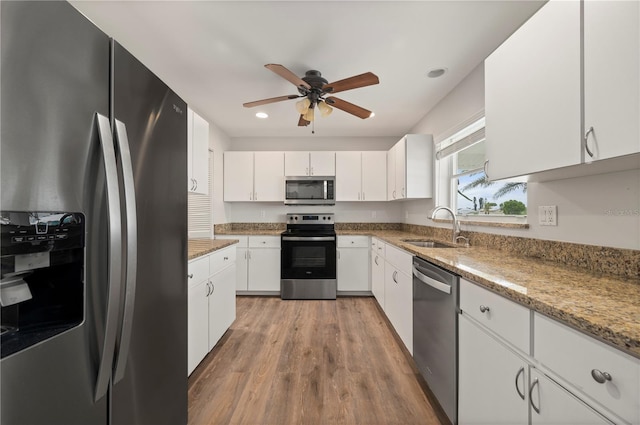 24261 Captain Kidd Blvd, Punta Gorda, FL 33955 - kitchen featuring stainless steel appliances, white cabinetry, ceiling fan, light wood-style flooring, and recessed lighting