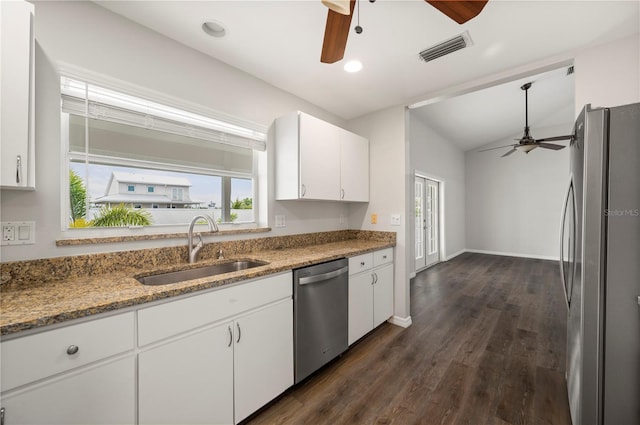 24261 Captain Kidd Blvd, Punta Gorda, FL 33955 - kitchen with stainless steel appliances, ceiling fan, white cabinets, dark wood-style floors, and light stone counters