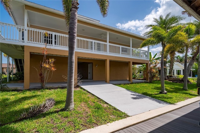 24261 Captain Kidd Blvd, Punta Gorda, FL 33955 - view of front of house with a front lawn and stucco siding
