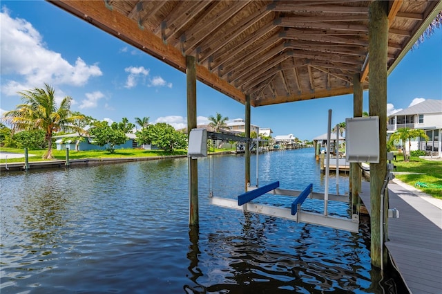 24261 Captain Kidd Blvd, Punta Gorda, FL 33955 - dock featuring boat lift, a water view, and a residential view