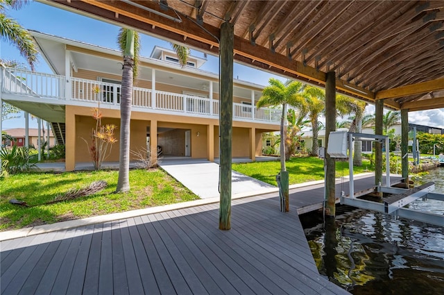 24261 Captain Kidd Blvd, Punta Gorda, FL 33955 - dock area with boat lift, a yard, and a water view