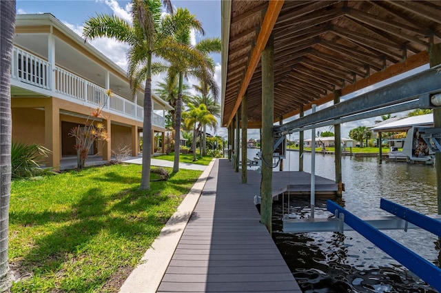 24261 Captain Kidd Blvd, Punta Gorda, FL 33955 - dock area featuring a water view, a lawn, and boat lift