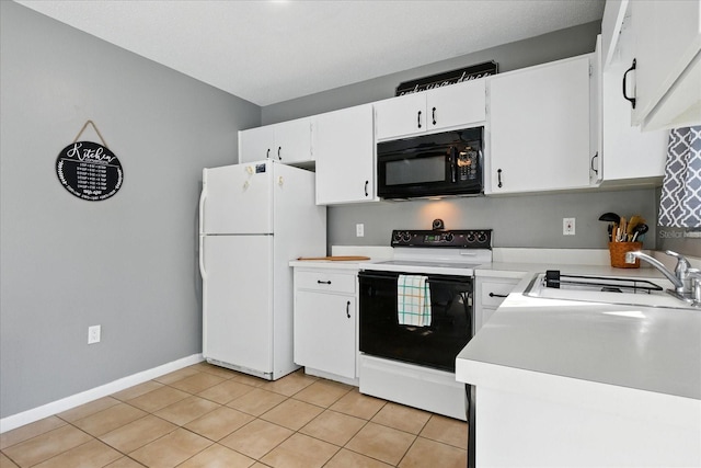 6382 Cutler Ter, Port Charlotte, FL 33981 - kitchen featuring black microwave, electric range, freestanding refrigerator, light countertops, and light tile patterned flooring