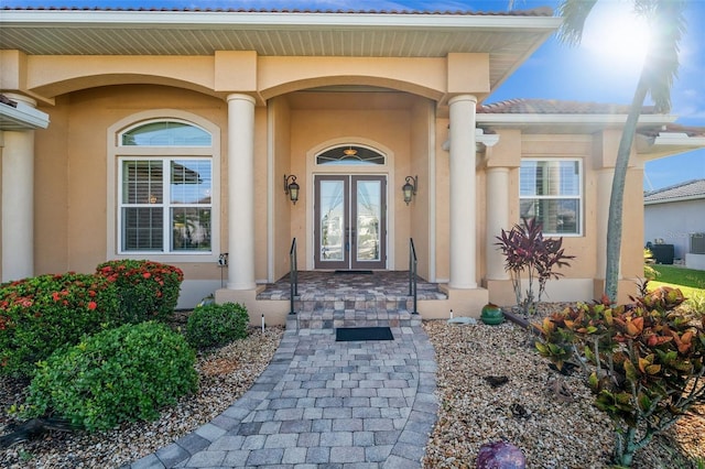 3322 Sandpiper Dr, Punta Gorda, FL 33950 - property entrance with stucco siding, french doors, and a porch