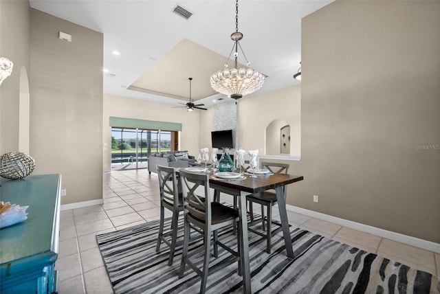 3322 Sandpiper Dr, Punta Gorda, FL 33950 - dining space with arched walkways, light tile patterned floors, ceiling fan, a tray ceiling, and recessed lighting