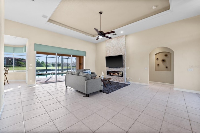 3322 Sandpiper Dr, Punta Gorda, FL 33950 - living area with a tray ceiling, ceiling fan, light tile patterned flooring, a fireplace, and recessed lighting