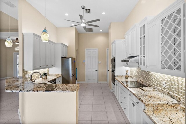 3322 Sandpiper Dr, Punta Gorda, FL 33950 - kitchen featuring black appliances, a ceiling fan, a peninsula, light stone countertops, and light tile patterned floors