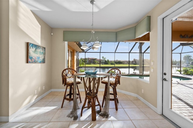 3322 Sandpiper Dr, Punta Gorda, FL 33950 - dining space featuring a sunroom, healthy amount of natural light, a water view, and light tile patterned floors