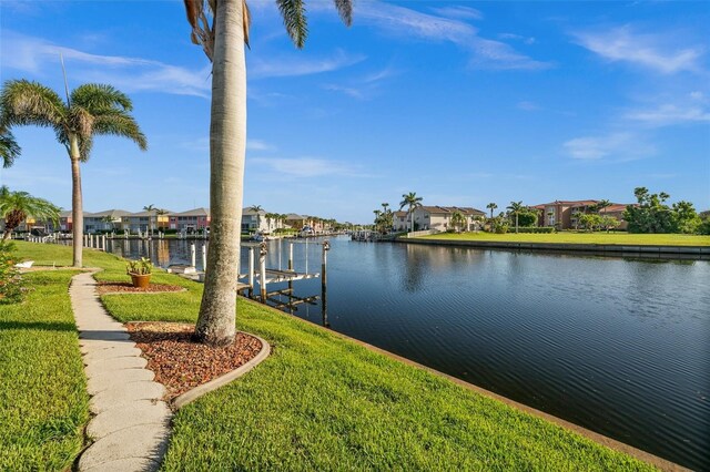 3322 Sandpiper Dr, Punta Gorda, FL 33950 - dock featuring a residential view, boat lift, a yard, and a water view