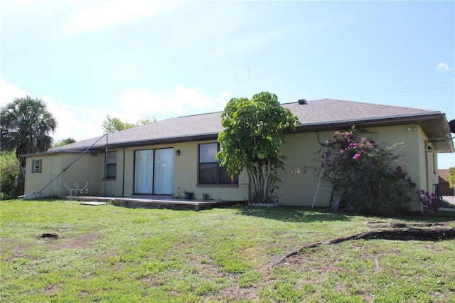 2467 Herron Ter, Port Charlotte, FL 33981 - back of house with a yard and stucco siding