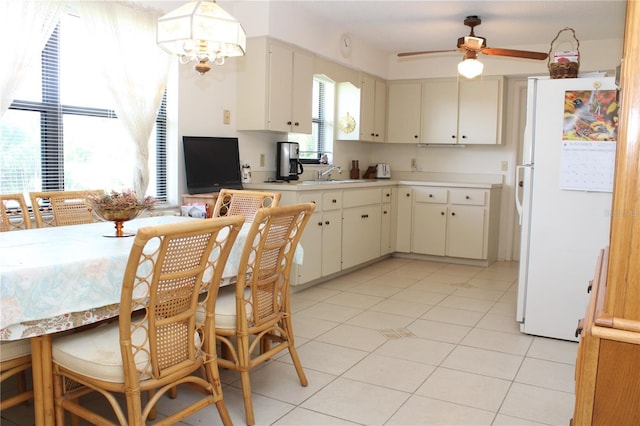 2467 Herron Ter, Port Charlotte, FL 33981 - kitchen featuring freestanding refrigerator, ceiling fan, light countertops, light tile patterned floors, and a chandelier