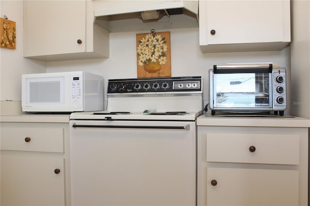2467 Herron Ter, Port Charlotte, FL 33981 - kitchen with white appliances, white cabinetry, extractor fan, and light countertops