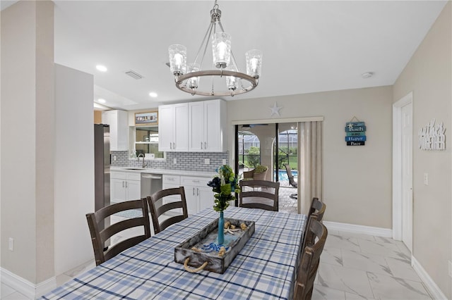 1141 Paraclete Rd, Punta Gorda, FL 33983 - dining space with a chandelier, light marble finish flooring, and recessed lighting