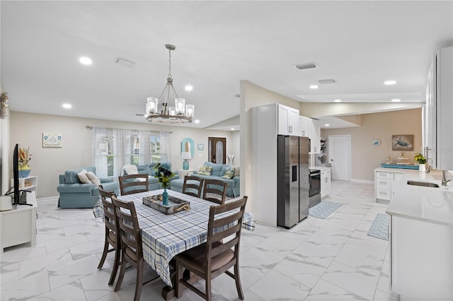 1141 Paraclete Rd, Punta Gorda, FL 33983 - dining room with light marble finish floors, a chandelier, and recessed lighting