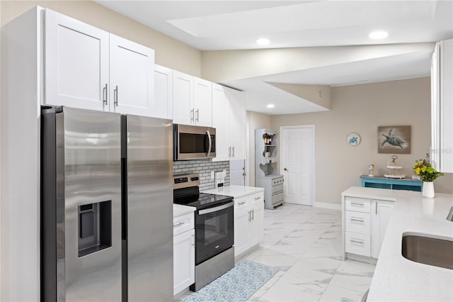 1141 Paraclete Rd, Punta Gorda, FL 33983 - kitchen featuring stainless steel appliances, recessed lighting, white cabinetry, tasteful backsplash, and light marble finish flooring