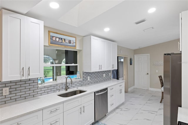 1141 Paraclete Rd, Punta Gorda, FL 33983 - kitchen featuring appliances with stainless steel finishes, white cabinets, recessed lighting, backsplash, and light marble finish flooring