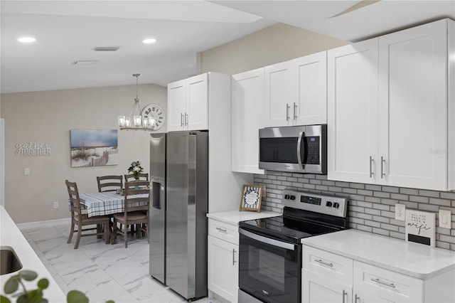 1141 Paraclete Rd, Punta Gorda, FL 33983 - kitchen with stainless steel appliances, light marble finish flooring, a chandelier, recessed lighting, and tasteful backsplash