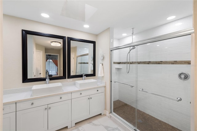 1141 Paraclete Rd, Punta Gorda, FL 33983 - bathroom featuring a stall shower, double vanity, marble finish flooring, recessed lighting, and a skylight