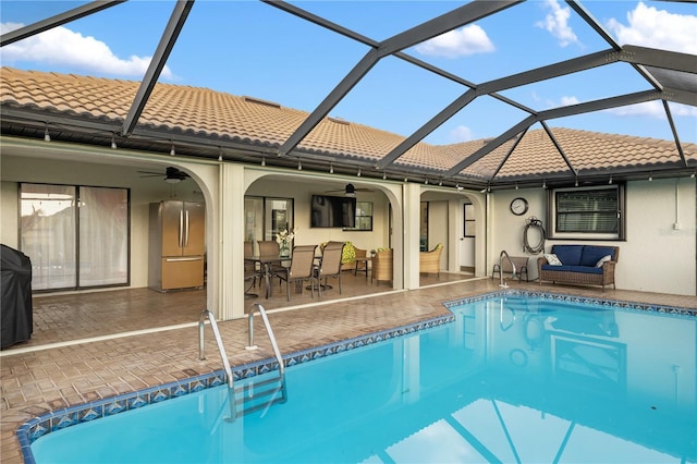 1141 Paraclete Rd, Punta Gorda, FL 33983 - swimming pool with ceiling fan, outdoor dining space, a patio area, and a lanai