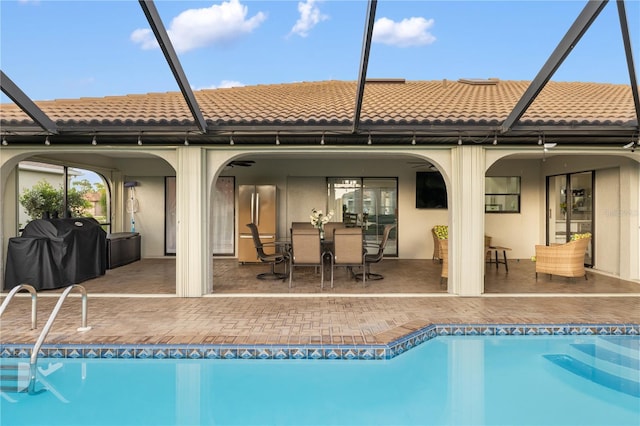 1141 Paraclete Rd, Punta Gorda, FL 33983 - back of property featuring glass enclosure, a tile roof, and stucco siding