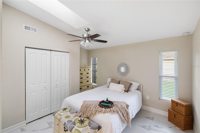 1141 Paraclete Rd, Punta Gorda, FL 33983 - bedroom featuring a skylight, light marble finish floors, a closet, lofted ceiling, and a ceiling fan