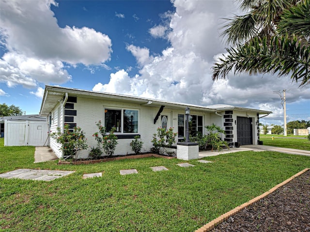 6483 Fabian Rd, North Port, FL 34287 - view of front of house featuring a garage, concrete driveway, a front yard, and brick siding