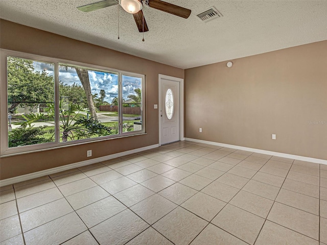 6483 Fabian Rd, North Port, FL 34287 - foyer entrance with a textured ceiling, a ceiling fan, and light tile patterned floors