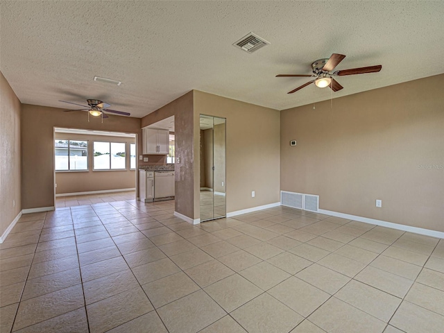 6483 Fabian Rd, North Port, FL 34287 - unfurnished room with a ceiling fan, a textured ceiling, and light tile patterned floors