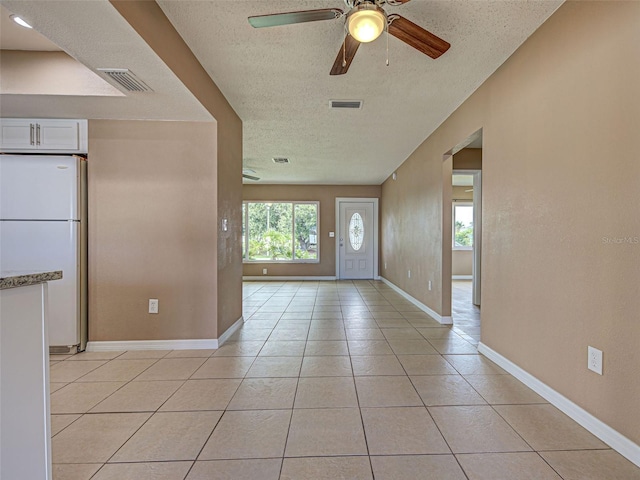 6483 Fabian Rd, North Port, FL 34287 - foyer entrance featuring a textured ceiling, ceiling fan, and light tile patterned floors