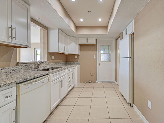 6483 Fabian Rd, North Port, FL 34287 - kitchen featuring white appliances, white cabinetry, light stone counters, light tile patterned floors, and recessed lighting